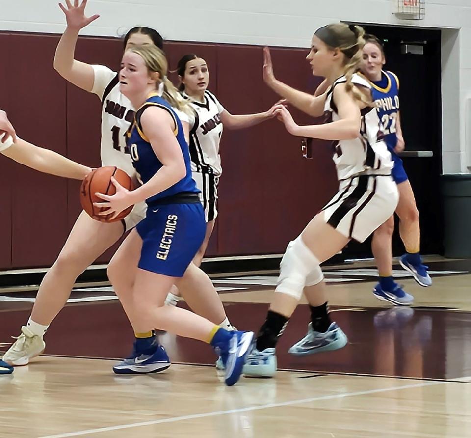 Philo's Halli Harris (4) maneuvers with the bal during the girls' basketball game against Philo at John Glenn High School on Saturday.