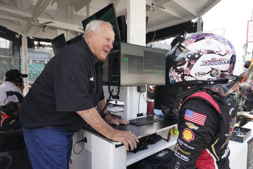 A. J. Foyt talks with Santino Ferrucci during practice for the IndyCar Grand Prix auto race at Indianapolis Motor Speedway, Friday, May 12, 2023, in Indianapolis. (AP Photo/Darron Cummings)