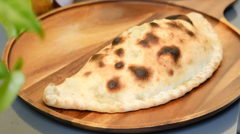 Calzone on wooden plate