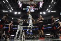 Milwaukee Bucks' Giannis Antetokounmpo dunks during the first half of Game 2 of their first round NBA playoff basketball game Wednesday, April 20, 2022, in Milwaukee. (AP Photo/Morry Gash)
