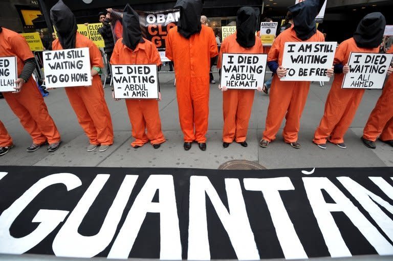 Protesters in New York's Times Square on April 11, 2013 demand the closure of the Guantanamo detention facility. Free them or put them on trial, thus urges a petition to President Barack Obama over the prisoners held at Guantanamo, jailed and in limbo for more than a decade