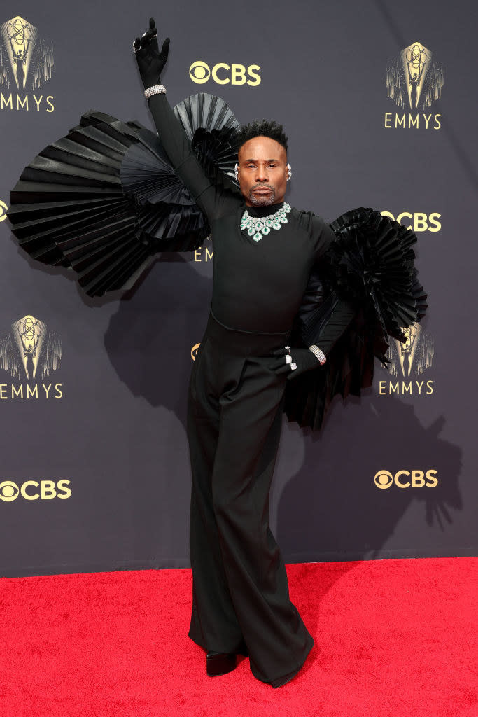 Billy Porter on the red carpet in a black wide-leg jumpsuit with frills on top