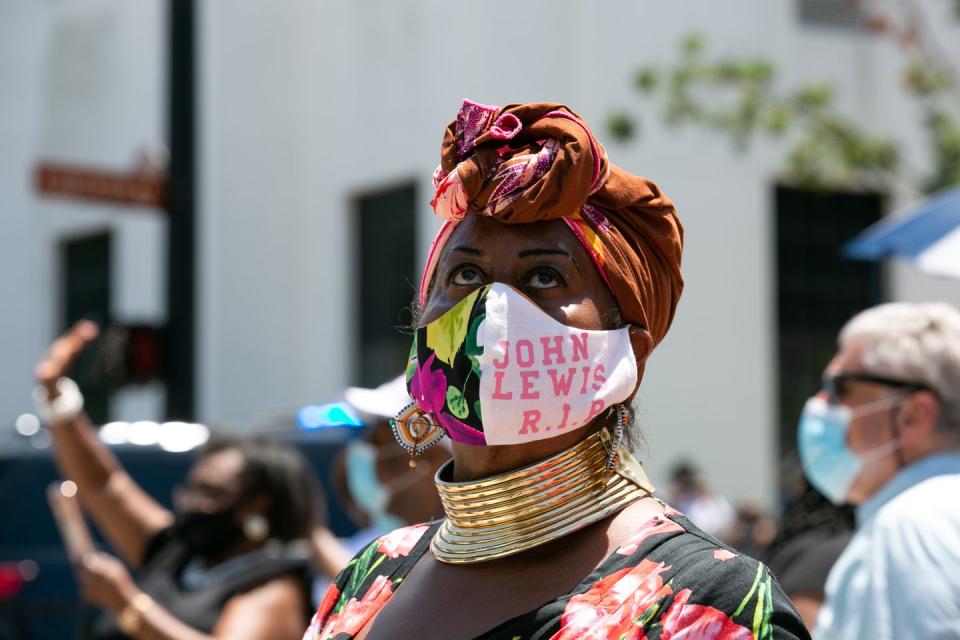 <p>Marion Glaser, a mourner, traveled from Mississippi to Montgomery in order to view Lewis's funereal procession. Glaser wore a protective face mask which read: "John Lewis R.I.P."<br></p>