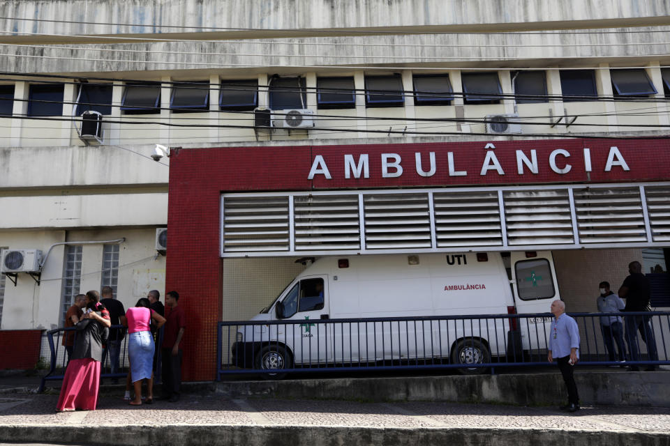 People wait outside the Getulio Vargas Hospital for the arrival of people who were injured or killed during a police raid in the Vila Cruziero favela of Rio de Janeiro, Brazil, Tuesday, May 24, 2022. Police in Rio de Janeiro raided the Vila Cruzeiro favela before dawn Tuesday in an operation that prompted a fierce firefight and state officials said at least 10 people died. (AP Photo/Bruna Prado)