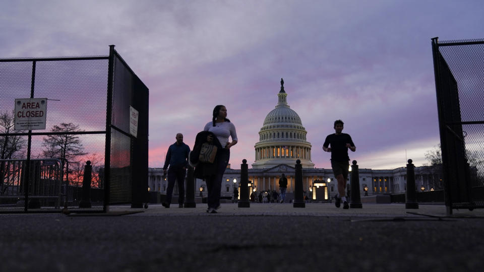 FILE - A perimeter fence around the U.S. Capitol is open for visitors to pass at sunset, Feb. 5, 2023, in Washington, ahead of the Tuesday evening State of the Union address. Biden on Tuesday night will stand before a joint session of Congress for the first time since voters in the midtem elections handed control of the House to Republicans. (AP Photo/Carolyn Kaster, File)