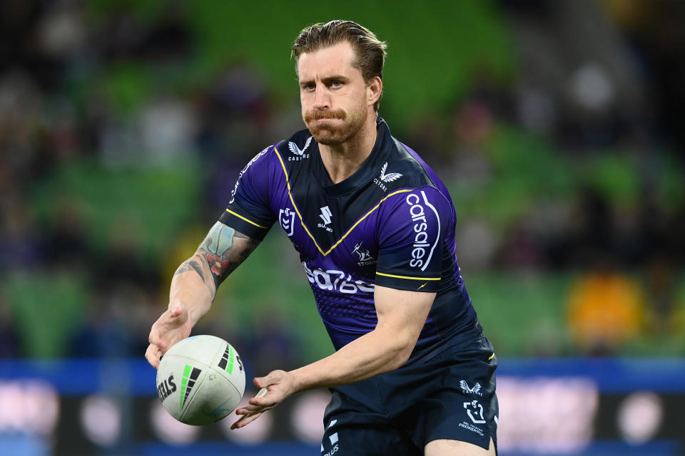 Seen here, Cameron Munster gets ready to pass the ball during an NRL game for the Melbourne Storm.