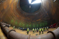 Journalist are seen inside a vast thermal tank to store hot water in Berlin, Germany, Thursday, June 30, 2022. Power provider Vattenfall unveiled a new facility in Berlin on Thursday that turns solar and wind energy into heat, which can be stored in a vast thermal tank and released into the German capital's grid as needed, smoothing out the fluctuating supply problem of renewables. (AP Photo/Michael Sohn)