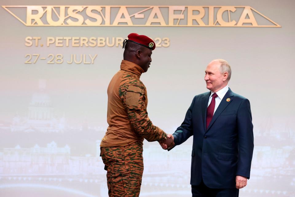 Burkina Faso's Capt. Ibrahim Traore, left, and Russian President <span class="caas-xray-inline-tooltip"><span class="caas-xray-inline caas-xray-entity caas-xray-pill rapid-nonanchor-lt" data-entity-id="Vladimir_Putin" data-ylk="cid:Vladimir_Putin;pos:1;elmt:wiki;sec:pill-inline-entity;elm:pill-inline-text;itc:1;cat:OfficeHolder;" tabindex="0" aria-haspopup="dialog"><a href="https://search.yahoo.com/search?p=Vladimir%20Putin" data-i13n="cid:Vladimir_Putin;pos:1;elmt:wiki;sec:pill-inline-entity;elm:pill-inline-text;itc:1;cat:OfficeHolder;" tabindex="-1" data-ylk="slk:Vladimir Putin;cid:Vladimir_Putin;pos:1;elmt:wiki;sec:pill-inline-entity;elm:pill-inline-text;itc:1;cat:OfficeHolder;" class="link ">Vladimir Putin</a></span></span> shake hands before an official ceremony to welcome the leaders of delegations to the Russia Africa Summit in St. Petersburg, Russia, Thursday, July 27, 2023. (Sergei Bobylev/TASS Host Photo Agency Pool Photo via AP)