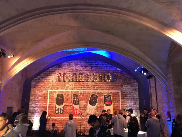 Members of the media crowd around the Nokia 3310 phones at the showcase.