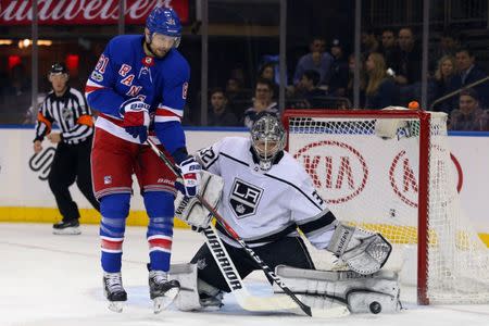 Dec 15, 2017; New York, NY, USA; Los Angeles Kings goalie Jonathan Quick (32) makes a save in front of New York Rangers left wing Rick Nash (61) during the second period at Madison Square Garden. Mandatory Credit: Brad Penner-USA TODAY Sports