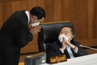 FILE - Thai Prime Minister Prayuth Chan-ocha, left, greets Deputy Prime Minister Prawit Wongsuwan at parliament on Saturday, July 23, 2022, in Bangkok, Thailand. Thailand’s Constitutional Court is set to rule Friday, Sept. 30, on whether Prime Minister Prayuth Chan-ocha has exceeded the term limits of his job and must leave office immediately. (AP Photo/Sakchai Lalit, File)
