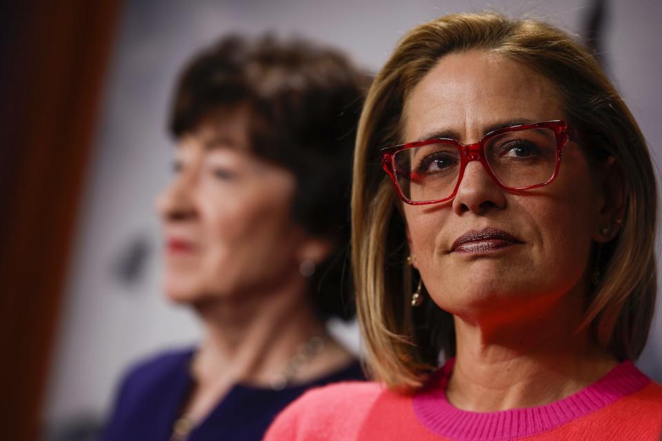 U.S. Sen. Kyrsten Sinema of Arizona, right, with GOP Sen. Susan Collins from Maine in the background, announced in December 2022 that she had left the Democratic Party and become an independent. <a href="https://www.gettyimages.com/detail/news-photo/sen-kyrsten-sinema-looks-on-as-sen-rob-portman-speaks-at-a-news-photo/1445582495?phrase=kyrsten%20sinema&adppopup=true" rel="nofollow noopener" target="_blank" data-ylk="slk:Anna Moneymaker/Getty Images;elm:context_link;itc:0;sec:content-canvas" class="link ">Anna Moneymaker/Getty Images</a>