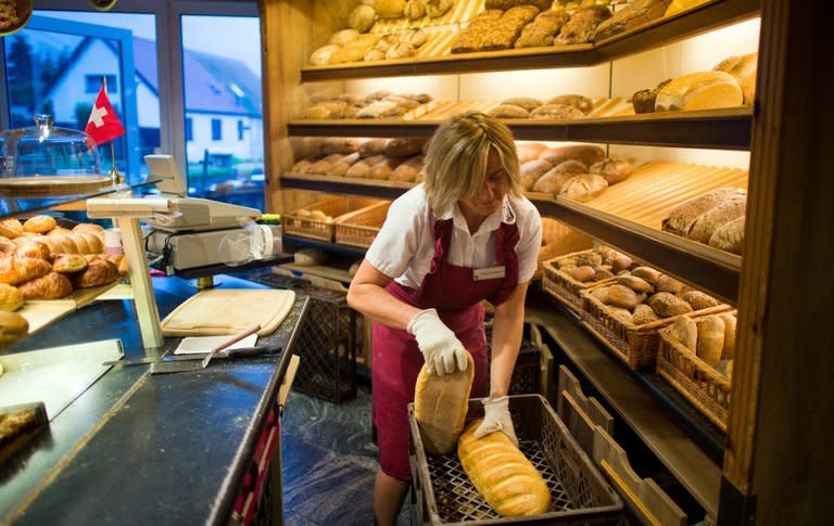 An employee arranges fresh bread at Plentz bakery in Schwante on July 1, 2013. Plentz employs about 100 people and counts five branches in the region around the town of Oranienburg, near Berlin