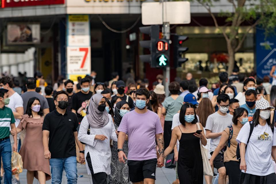  People are wearing face masks as a preventive measure against the spread of covid-19 while walking along Orchard Road, a famous shopping district in Singapore.