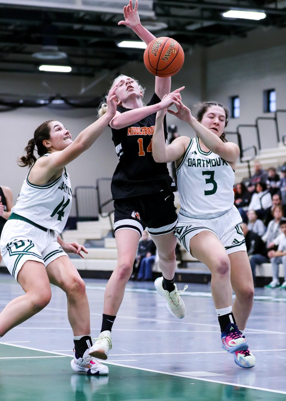 Middleboro's Hailey Iwanksi gets fouled by Dartmouth's Kaelyn Zuber (No. 3) and Abbie Zuber during a preliminary game in the Div. 2 state tournament on Monday, Feb. 27, 2023.