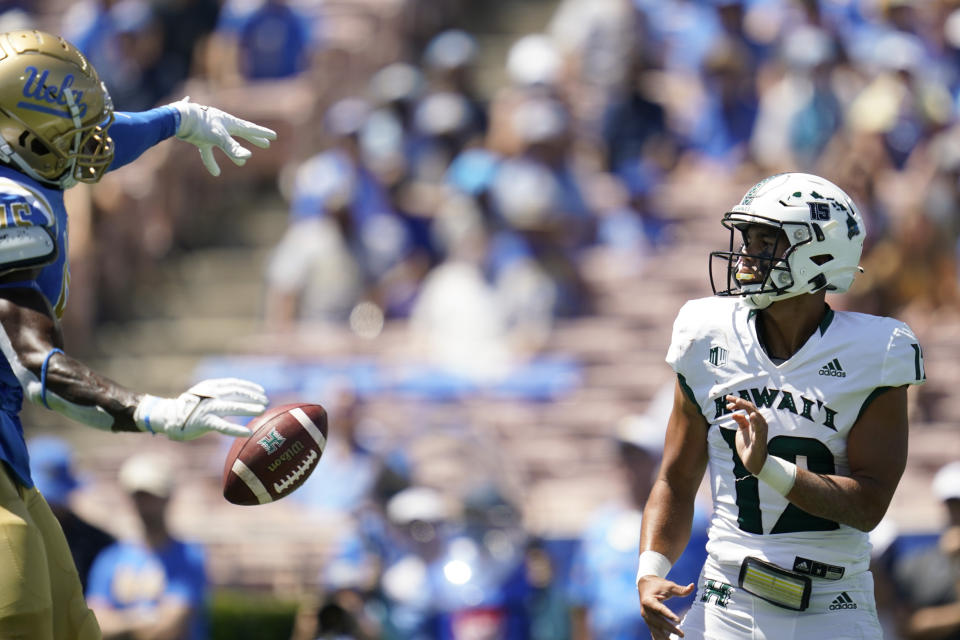 UCLA Bruins linebacker Mitchell Agude (45) blocks a throw by Hawaii Warriors quarterback Chevan Cordeiro (12) during the first half of an NCAA college football game Saturday, Aug. 28, 2021, in Pasadena, Calif. (AP Photo/Ashley Landis)