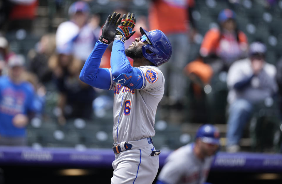 New York Mets' Starling Marte gestures skyward as he crosses home plate after hitting a two-run home run off Colorado Rockies starting pitcher German Marquez in the first inning during the first baseball game of a doubleheader, Saturday, May 21 2022, in Denver. (AP Photo/David Zalubowski)