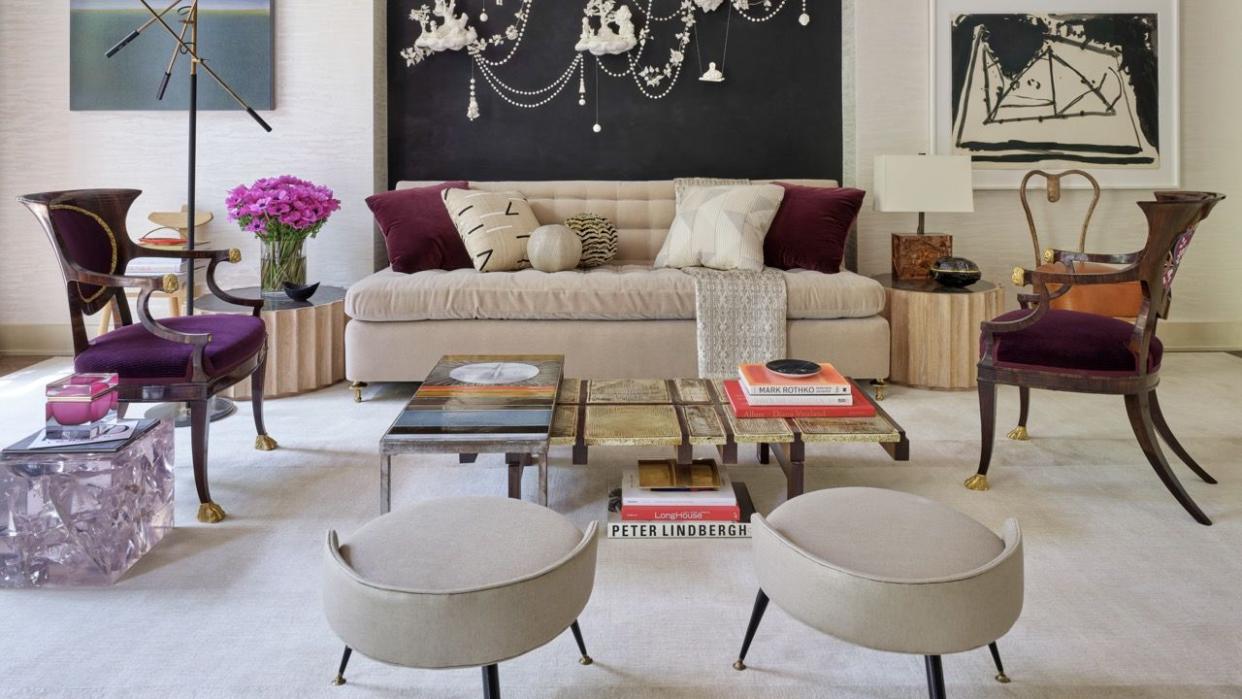 a living room with a large blackboard and chairs