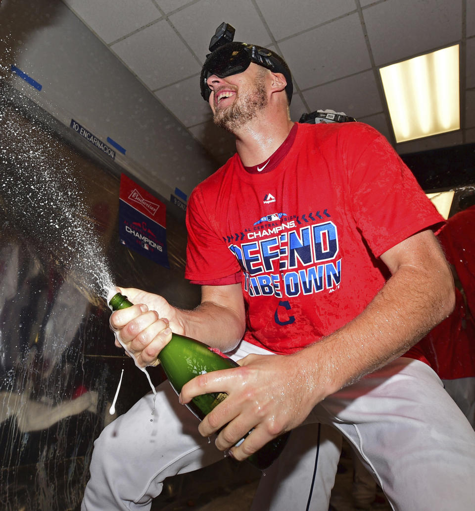 Cleveland Indians starting pitcher Trevor Bauer celebrates in the clubhouse after the Indians defeated the Detroit Tigers 15-0 to clinch the American League Central Division, in a baseball game, Saturday, Sept.15, 2018, in Cleveland. (AP Photo/David Dermer)