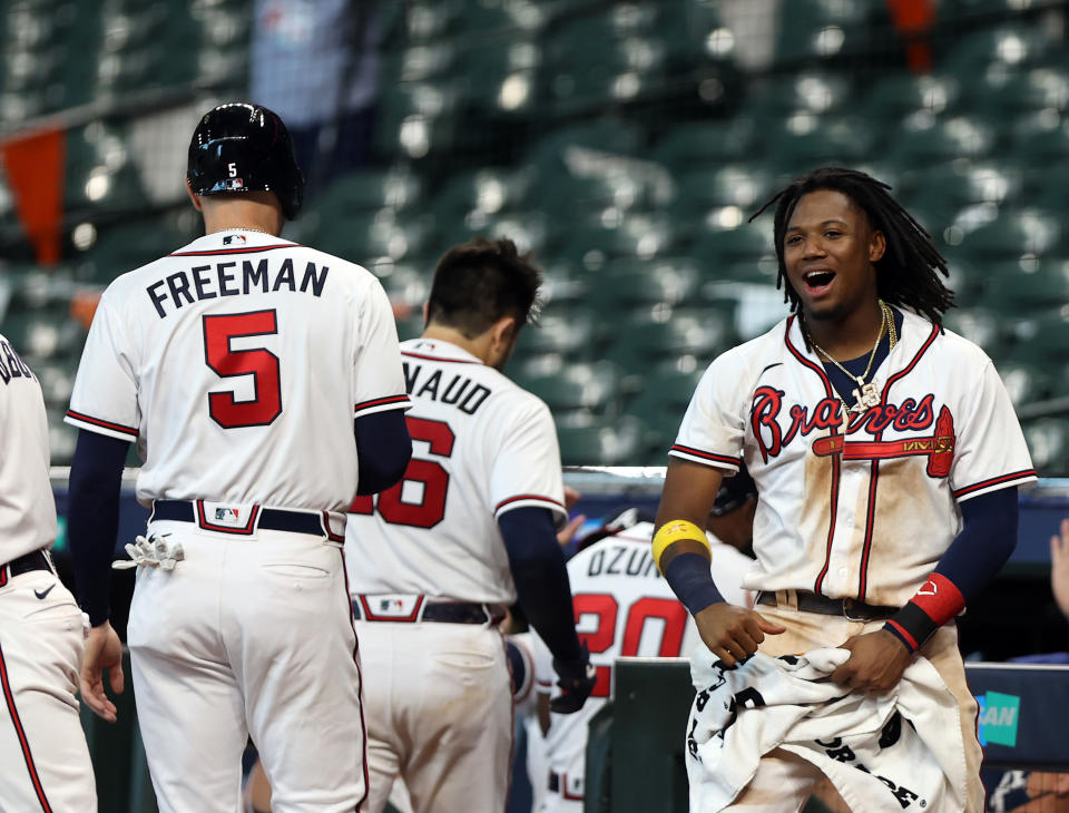 HOUSTON, TX - OCTOBER 06: Ronald Acuna Jr. #13 of the Atlanta Braves celebrates with Freddie Freeman #5 after Travis dArnaud #16 hit a three-run home run in the seventh inning of Game 1 of the NLDS between the Atlanta Braves and the Miami Marlins at Minute Maid Park on Tuesday, October 6, 2020 in Houston, Texas. (Photo by Michael Starghill/MLB Photos via Getty Images)