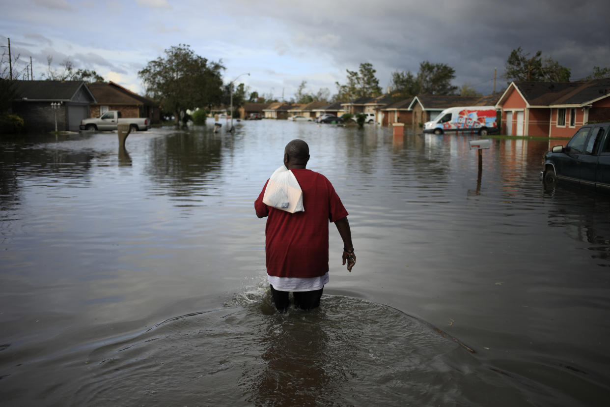 A resident walks through floodwater