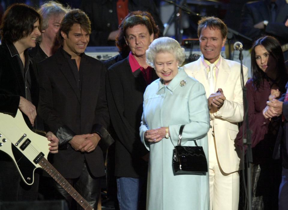 Britain's Queen Elizabeth II meets Sir Paul McCartney, Sir Cliff Richard and other peeformers on stage in the gardens of Buckingham Palace, after the second concert to commemorate the Golden Jubilee of Britain's Queen Elizabeth II. * Some 12,000 tickets were distributed by ballot for the Party at the Palace, and ten of thousands more gathered outside to enjoy the music. Later The Queen lit a beacon and watched a firework display. On Tuesday she will travel to the St Paul's for a service of thanksgiving. (Photo by Stefan Rousseau - PA Images/PA Images via Getty Images)