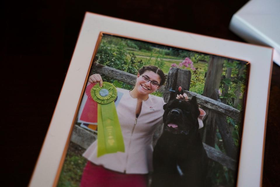 A photograph of Lihi Ruvio, 17, with her dog Royal is displayed inside the Ruvio's home in Williamston on March 8, 2023. Royal is the No. 1 lifetime ranked owner-handled cane corso in the country and Westminster two-time Select Dog winner.