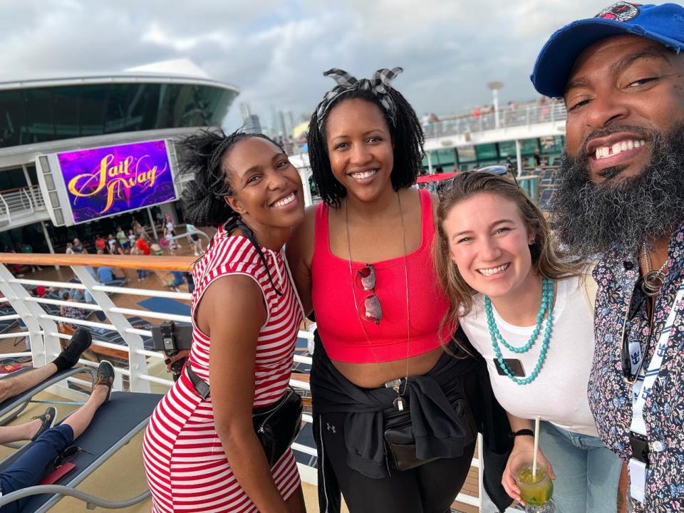 group of four people on the deck of a cruise ship