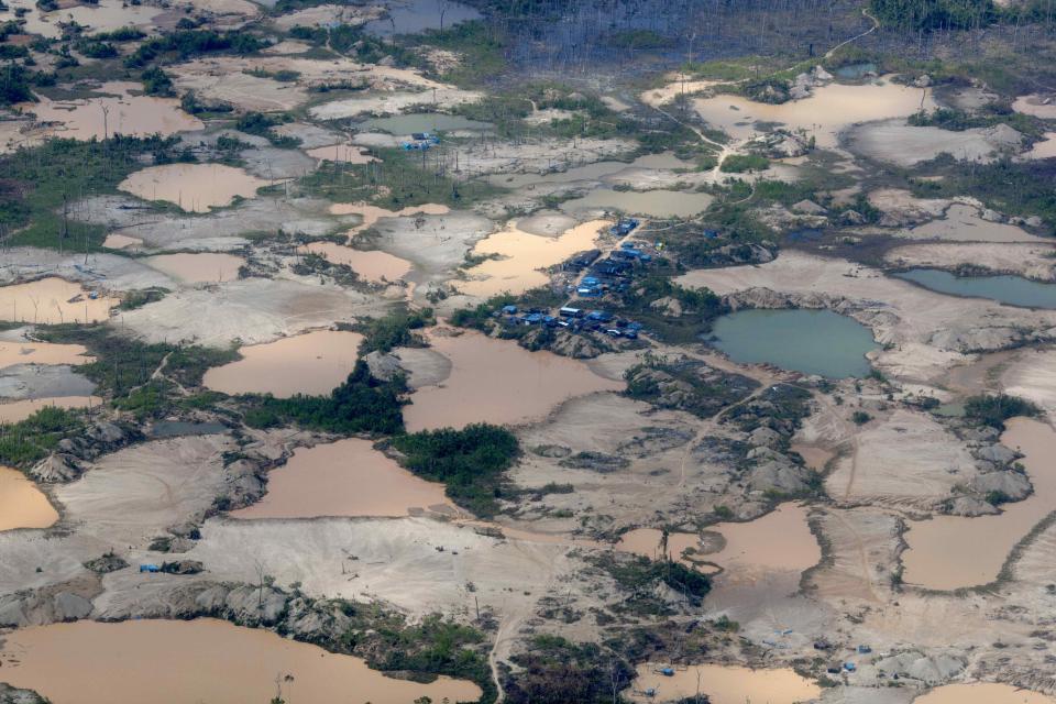 FILE - This Sept. 13, 2013 aerial file photo shows tailings produced by informal mining in Peru's Madre de Dios region. A study of mercury contamination from rampant informal gold mining in Peru's Amazon says indigenous people who get their protein mostly from fish are the most affected, particularly their children. The clock has run out for an estimated 40,000 illegal gold miners who had until Saturday to legalize their status in a region of southeastern Peru where fortune-seekers have ravaged rainforests and contaminated rivers. (AP Photo/Rodrigo Abd, File)