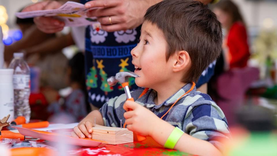 Families participated in a variety of activities at the tree lighting event at Naval  Air Station Jacksonville, Fla. on Dec. 1. Kids could build their own Christmas car, or sailboat at the kids' holiday workshop provided by The Home Depot. (Photo courtesy of The Home Depot)