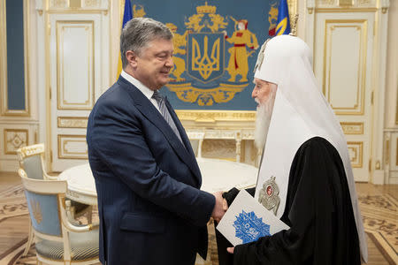 Ukrainian President Petro Poroshenko meets with Patriarch Filaret, head of Ukraine’s Orthodox Church, in Kiev, Ukraine April 18, 2018. Mikhail Palinchak/Ukrainian Presidential Press Service/Handout via REUTERS