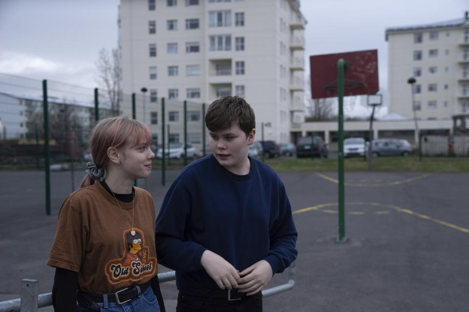 This photo taken Monday, May 13, 2019, shows Karen Guttensen and Ingvar Ingolfsson, right, both 14-years old, outside the Tjornin youth center in Reykjavik, Iceland, on a bright summer night. The island nation in the North Atlantic has dried up a teenage culture of drinking and smoking by focusing on local participation in music and sports options for students, with such success that Icelandic teens now have one of the lowest rates of substance abuse in Europe. (AP Photo/Egill Bjarnason)