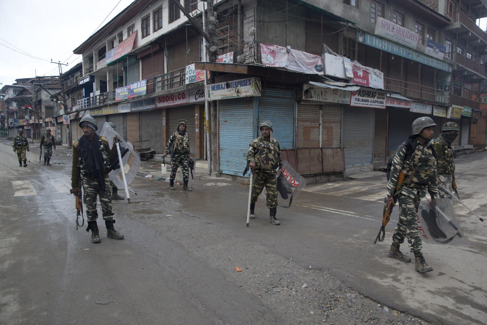 Indian paramilitary soldiers patrol a deserted street during the second phase of India's general elections, in Srinagar, Indian controlled Kashmir, Thursday, April 18, 2019. Kashmiri separatist leaders who challenge India's sovereignty over the disputed region have called for a boycott of the vote. Most polling stations in Srinagar and Budgam areas of Kashmir looked deserted in the morning with more armed police, paramilitary soldiers and election staff present than voters. (AP Photo/ Dar Yasin)