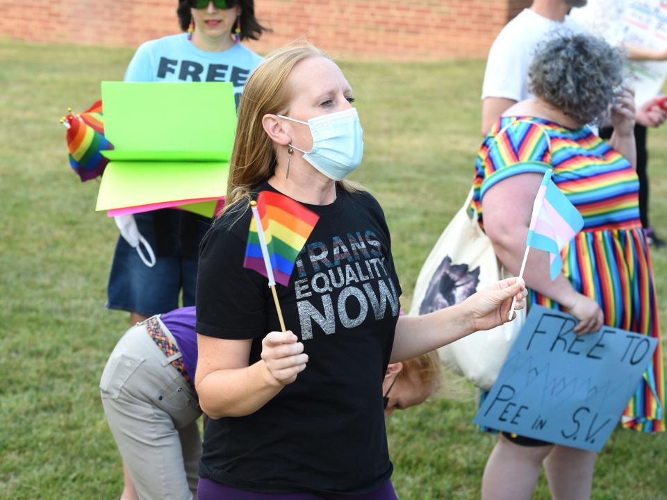 In July 2021, as Augusta County Public Schools discussed model policies to protect transgender students, supporters of the policies gather outside school board meeting at Wilson Memorial High School.