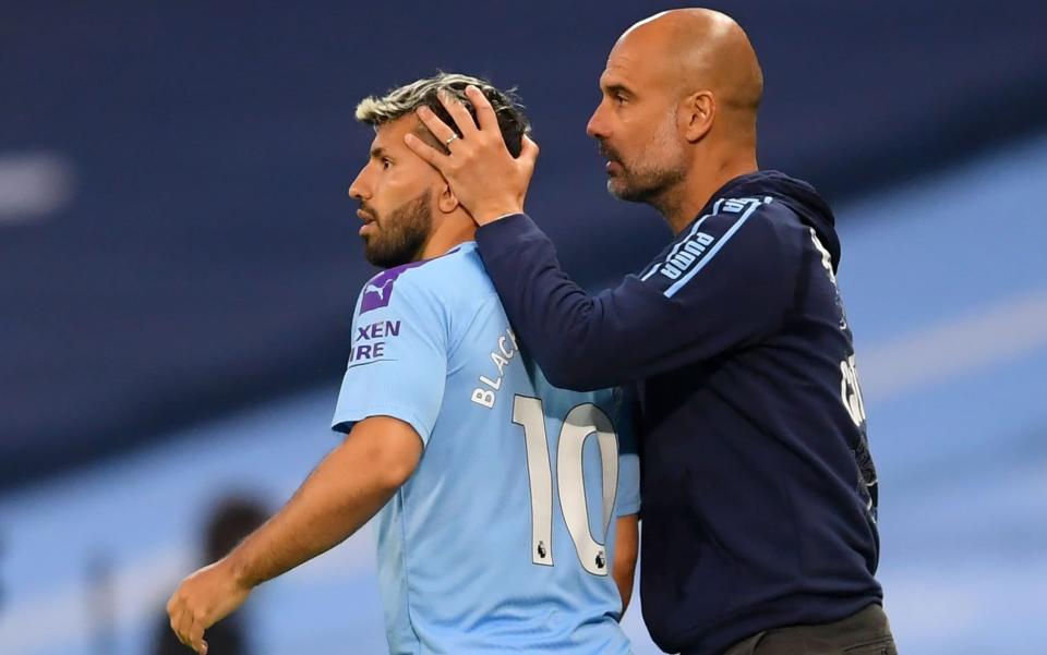 Manchester City's Spanish manager Pep Guardiola puts his hands on Manchester City's Argentinian striker Sergio Aguero as he is substitued on during the English Premier League football match between Manchester City and Arsenal at the Etihad Stadium in Manchester, north west England, on June 17, 2020. - AFP via Getty Images