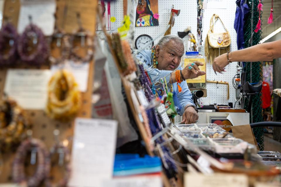 Larry Running Turtle Salazar sells a bracelet in his shop, Ishka Trading Post, in the Corpus Christi Trade Center on March 10, 2023, in Texas.