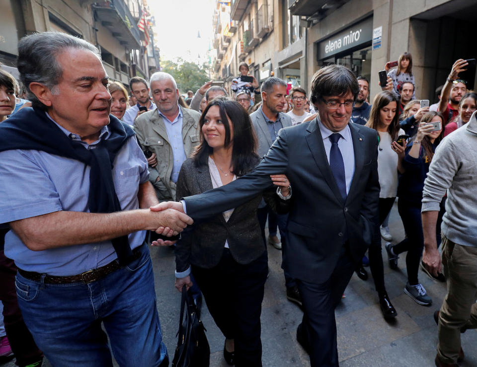 <p>Sacked Catalan President Carles Puigdemont (R) walks with his wife Marcela Topor as he greets a supporter after leaving a restaurant the day after the Catalan regional parliament declared independence from Spain in Girona, Spain, Oct. 28, 2017. (Photo: Rafael Marchante/Reuters) </p>