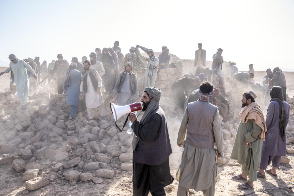 Afghan volunteers clean up rubble after an earthquake in Zenda Jan district in Herat province, western of Afghanistan, Wednesday, Oct. 11, 2023. Another strong earthquake shook western Afghanistan on Wednesday morning after an earlier one killed more than 2,000 people and flattened whole villages in Herat province in what was one of the most destructive quakes in the country's recent history. (AP Photo/Ebrahim Noroozi)