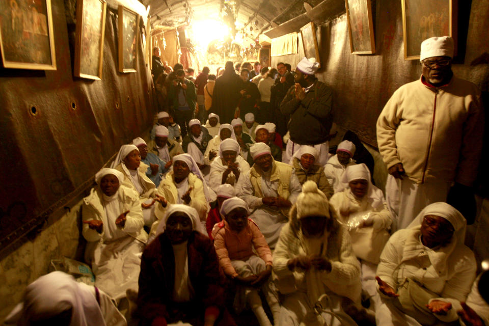 Christian worshippers from Nigeria pray at the Church of Nativity, traditionally believed by Christians to be the birthplace of Jesus Christ, in the West Bank town of Bethlehem on Christmas Eve, Tuesday, Dec. 24, 2013. (AP Photo/Majdi Mohammed)