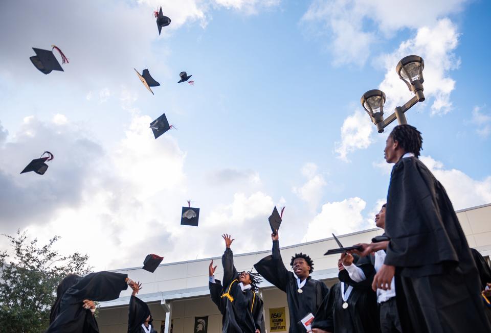 Graduating seniors toss their caps at a ceremony in Palm Beach County in 2023. Palm Beach County's school district is a county-wide system that doesn't always build schools with respects to city boundaries. With the approval of a Riviera Beach high school, is that changing?
