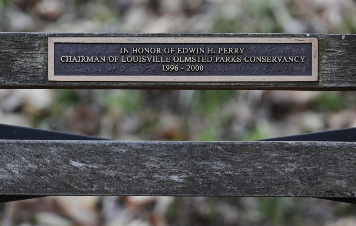 A bench in honor of Edwin H. Perry, former chairman of Olmsted Parks Conservancy, is inside Cherokee Park in Louisville, Ky. on March 25, 2024. The 50th anniversary of the 1974 tornado which destroyed most of the trees in the area is approaching.