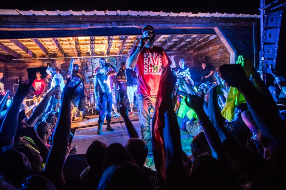 Redneck Rave creator and music artist Justin Stowers performs with other country rap artists during the Redneck Rave at BlackSwan Mudpit in Medora, Ind., on July 20, 2018. Stowers, a self proclaimed city-boy from Fort Wayne, started the Redneck Rave in 2016. The event has since moved slightly south to Kentucky.