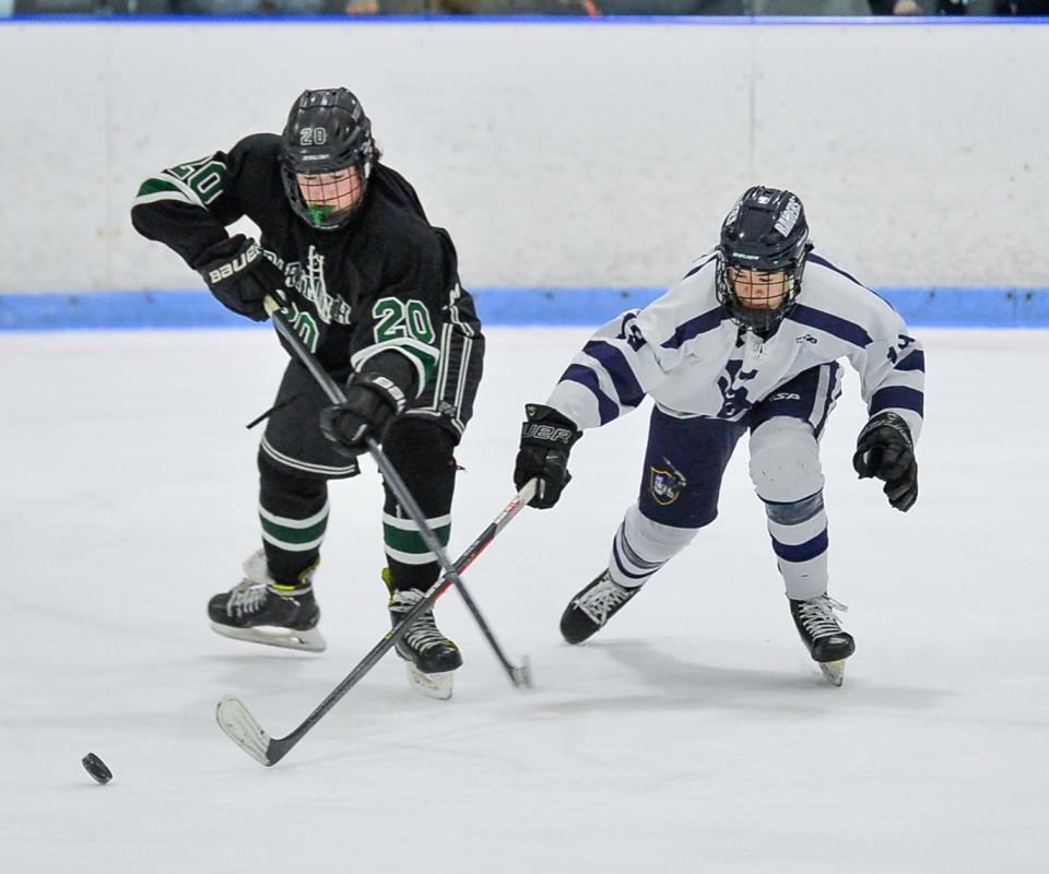 Dartmouth’s Jacob Kerney and Somerset Berkley’s Kein Stafford attempt to gain control of the puck .