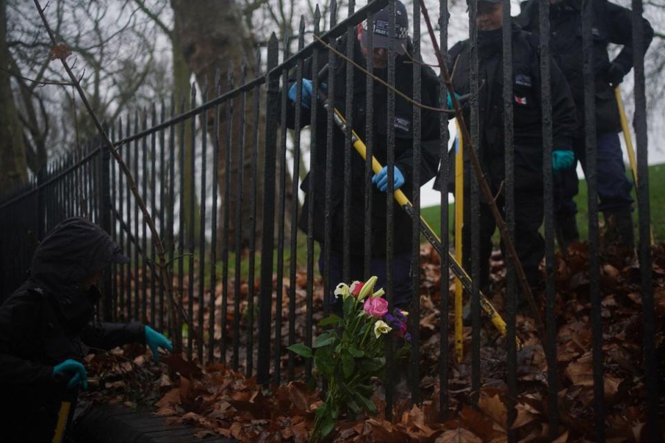 Police officers conducting a search near the scene of Harry's murder (PA)