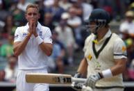 England's Stuart Broad (L) reacts after bowling to Australia's Shane Watson during the first day's play in the second Ashes test cricket match at the Adelaide Oval December 5, 2013.