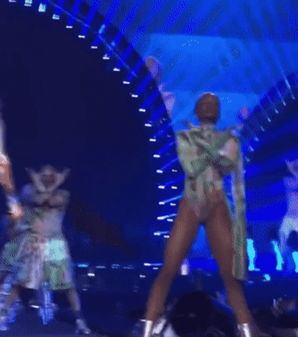 GIF of dancer knocking the garment offstage with their foot