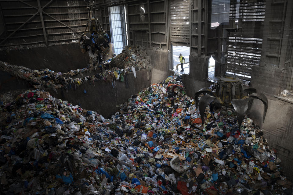 Cranes lift waste, mostly plastic and paper at the GreenNet recycling plant in Atarot industrial zone, north of Jerusalem, Wednesday, Jan. 25, 2023. Israel's new government is in the process of repealing a new tax on single-use plastics. Ultra-Orthodox Jews, who have large families and use large quantities of disposable cups, plates and cutlery, say the tax unfairly targeted them. (AP Photo/Oded Balilty)