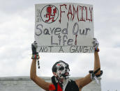 <p>Fonz Tobin, 25, from Albuquerque, N.M., holds up a sign in front of the Lincoln Memorial in Washington, as he joins other supporters of the rap group Insane Clown Posse, during a rally Saturday, Sept. 16, 2017, to protest and demand that the FBI rescind its classification of the juggalos as “loosely organized hybrid gang.” (Photo: Pablo Martinez Monsivais/AP) </p>