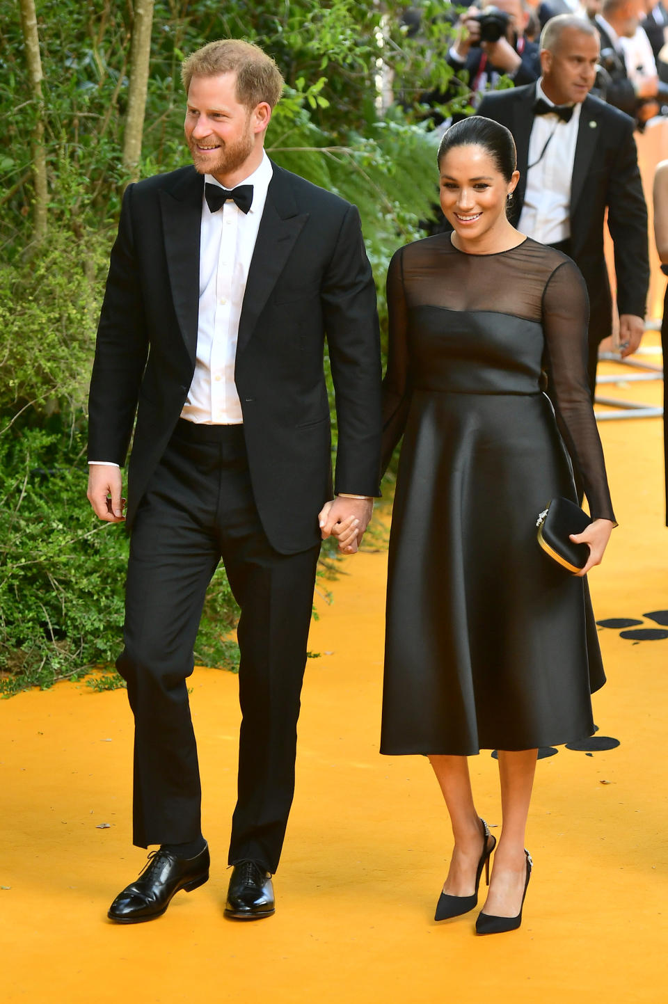 For her first post-pregnancy red carpet appearance, the Duchess of Sussex reminded us why she's the nation's go-to style muse in a £3,454 black satin dress with sheer sleeves by Jason Wu. A £1,680 Gucci clutch and matching shoes completed the winning ensemble. <em>[Photo: Getty]</em>