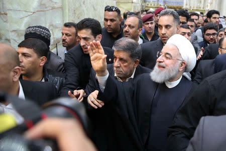 Iranian President Hassan Rouhani waves to the people at the Imam Ali shrine in Najaf, Iraq March 13, 2019. Official Iranian President website/Handout via REUTERS